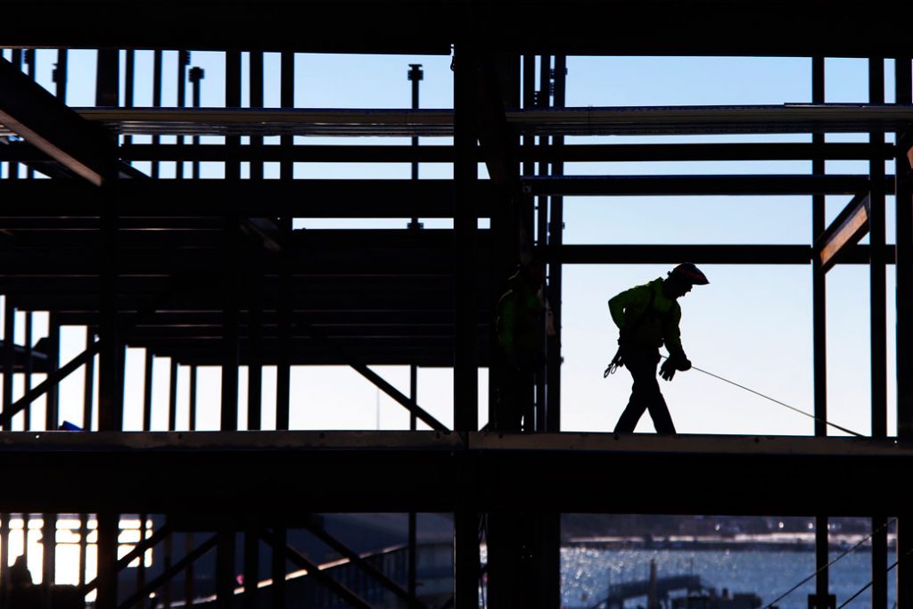 A welder takes measurements on the third floor of a hotel construction site in Portland, Maine, March 2017. (Getty/Ben McCanna)